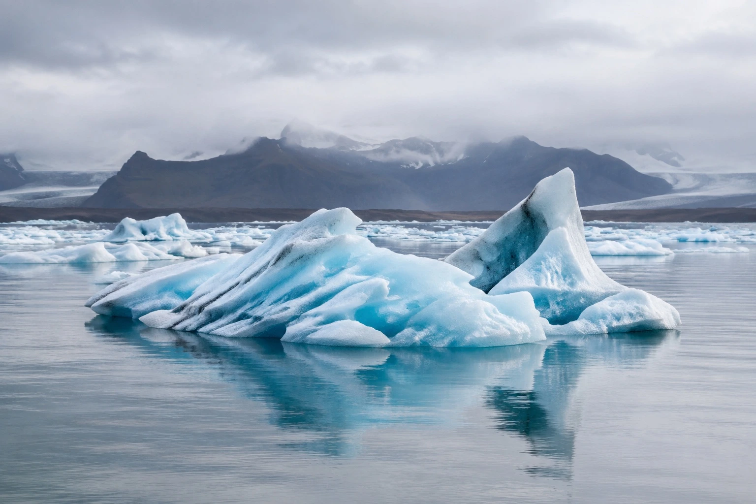 Blue glacier ice on a still Icelandic lagoon